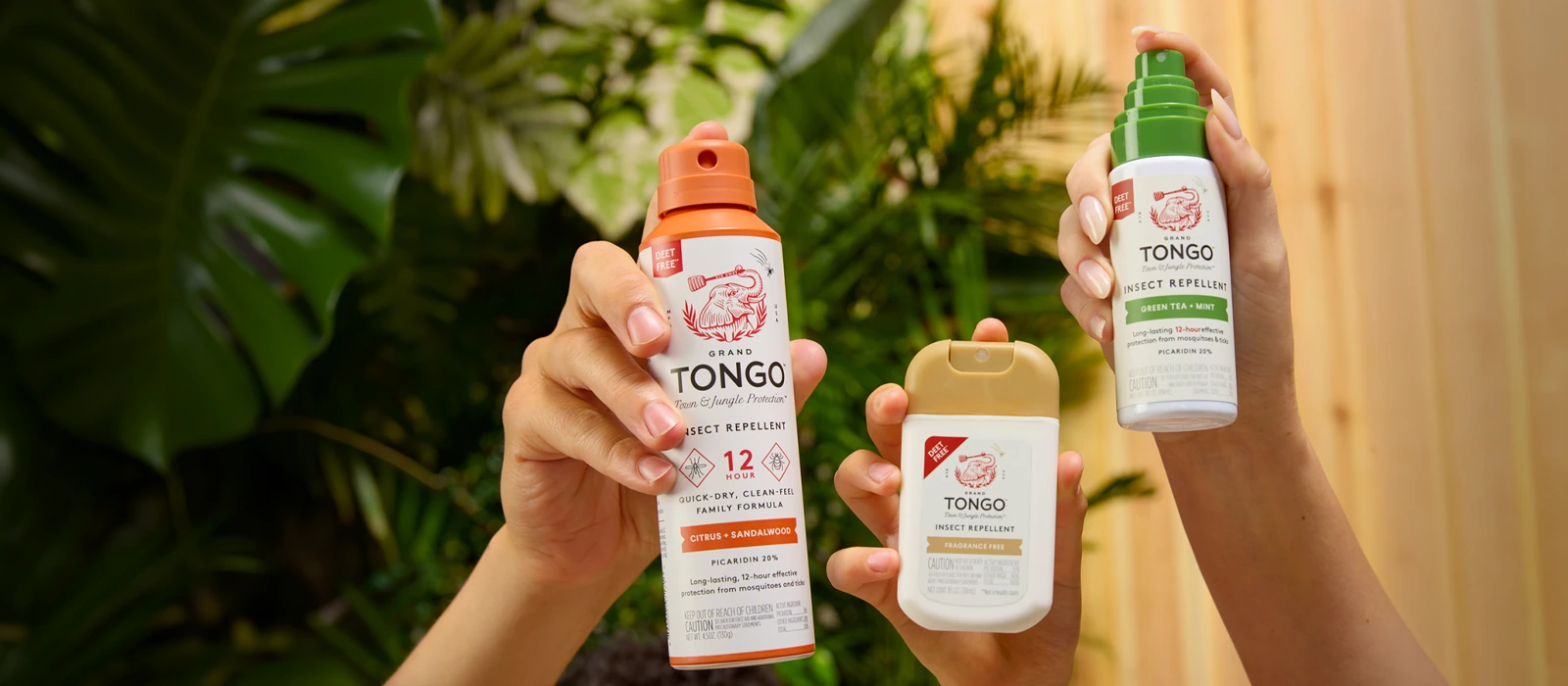 Hands holding Grand Tongo Full Size Spray, Pocket Spray and Travel Pump Spray outdoors