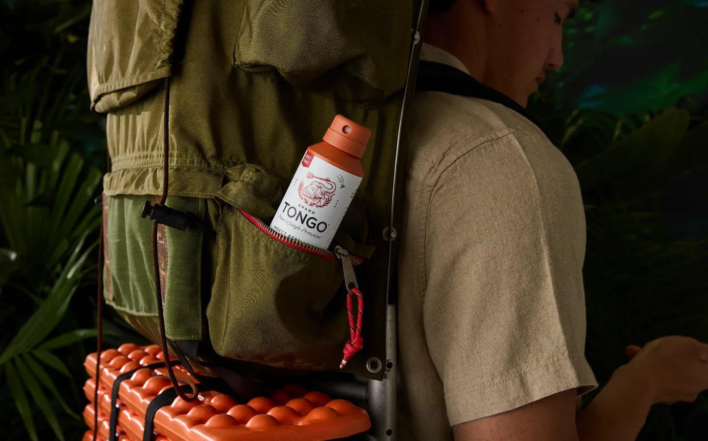 Grand Tongo Citrus + Sandalwood Full Size Spray tucked in an outdoor backpack pocket