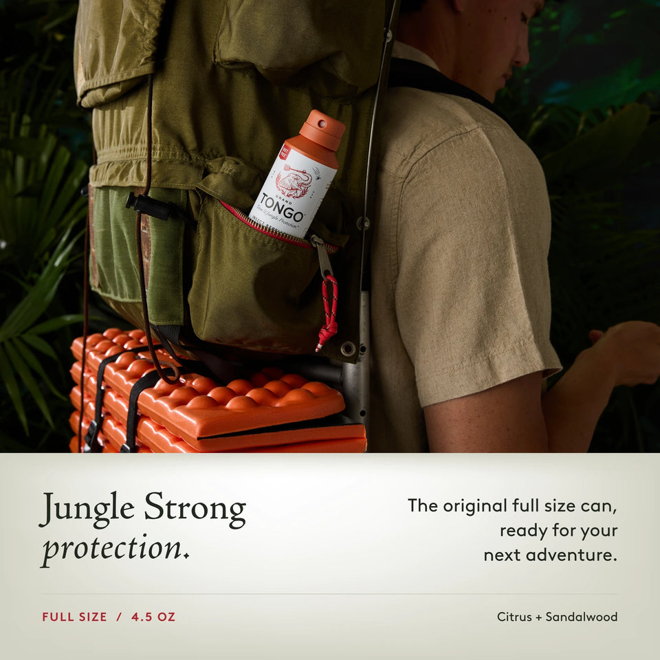 Grand Tongo Citrus + Sandalwood Full Size Spray, 4.5 oz carried in a backpack pocket beside hiking gear. Jungle Strong protection. The original full size can, ready for your next adventure.