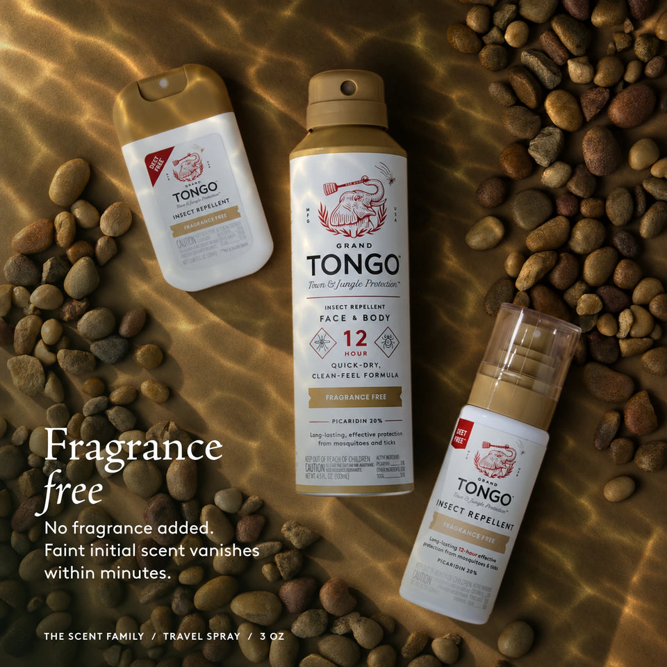 The Grand Tongo Fragrance Free scent family: full-size, travel, and pocket sprays arranged on warm neutral fabric, pebbles, and light patterns. This is a scent-family image, not the quantity included in the selected product. Fragrance free. No fragrance added. Faint initial scent vanishes within minutes. The scent family / Travel Pump Spray / 3 oz.