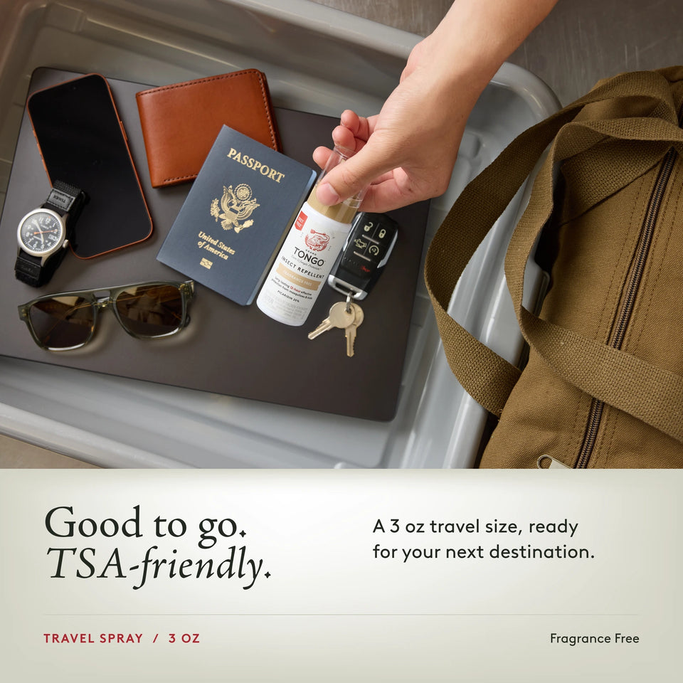 Grand Tongo Fragrance Free Travel Pump Spray, 3 oz held over a travel tray alongside a passport, phone, wallet, watch, sunglasses, keys, and bag. Good to go. TSA-friendly. A 3 oz travel size, ready for your next destination.